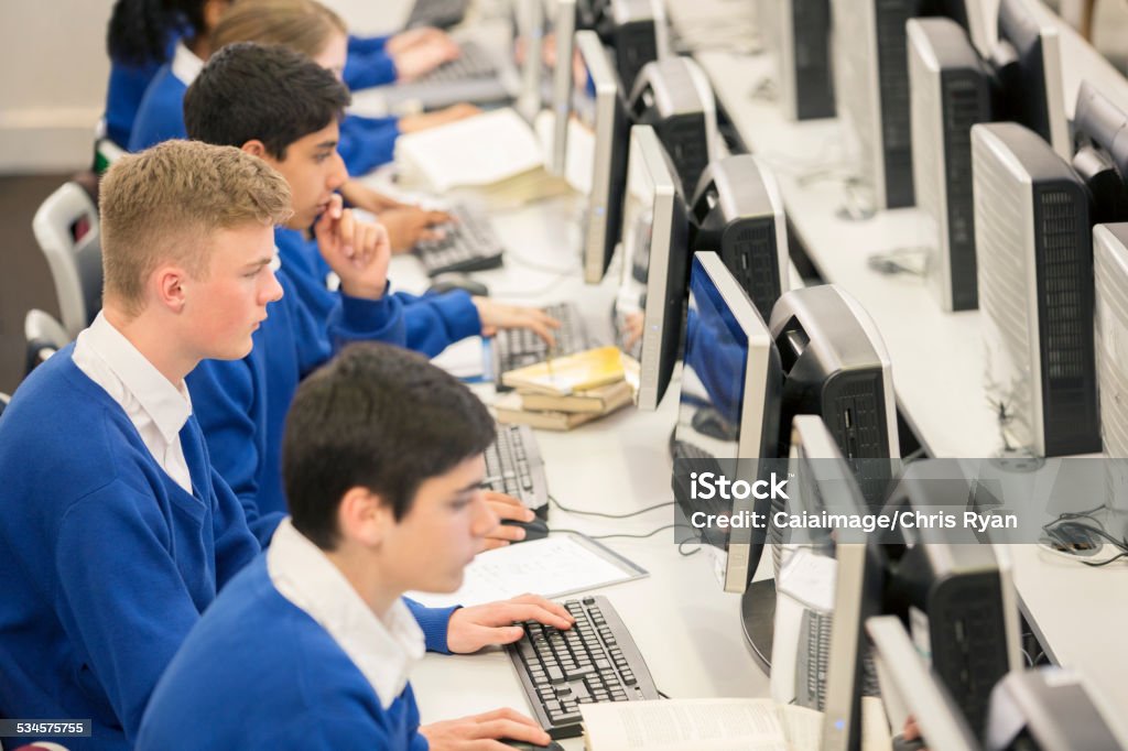 Teenage students using computers in computer room  Education Stock Photo