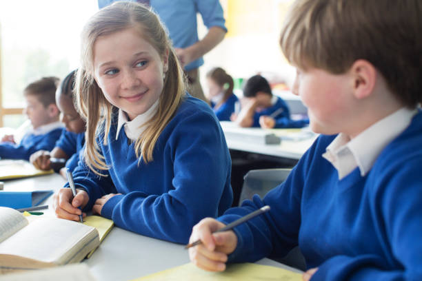 istock Schoolgirl and schoolboy learning in classroom 534575761