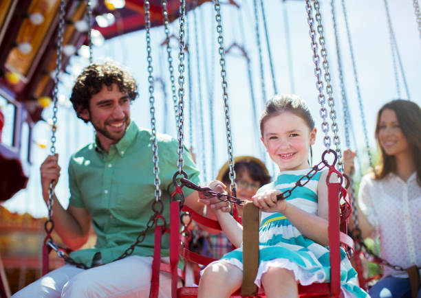 istock Family on carousel in amusement park 534576821