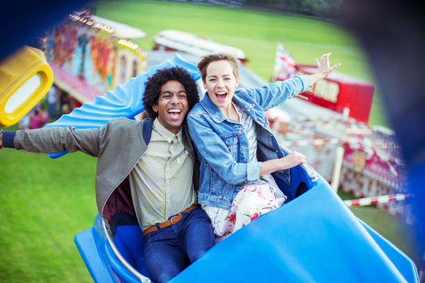 istock Cheerful couple having fun on carousel in amusement park 534577049