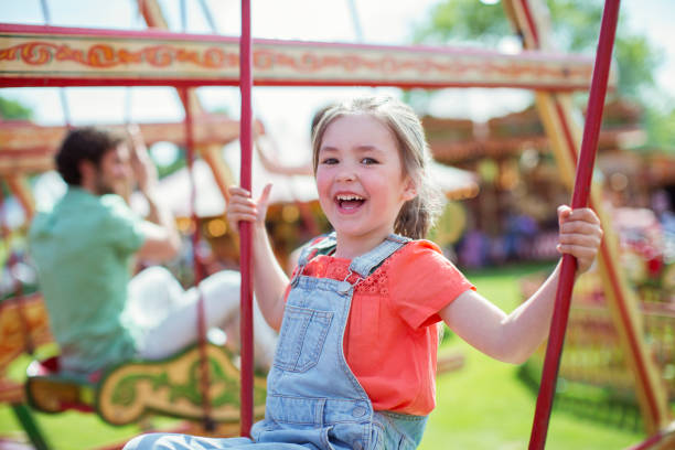 istock Cheerful girl laughing on carousel in amusement park 534577085