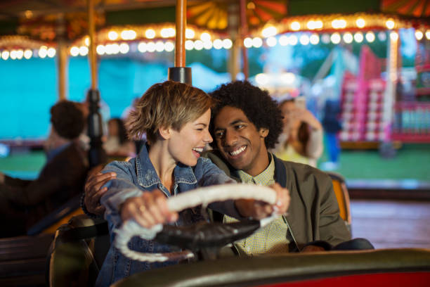 istock Young couple on bumper car ride in amusement park 534577169