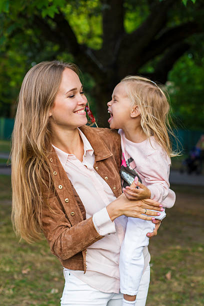 istock woman with child having fun in park 534596520