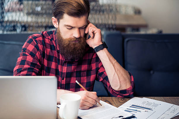 istock Brutal bearded man talking on cell phone 534596842