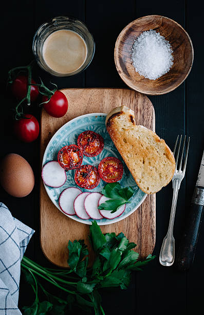 Brunch or breakfast with baked tomatoes and radishes