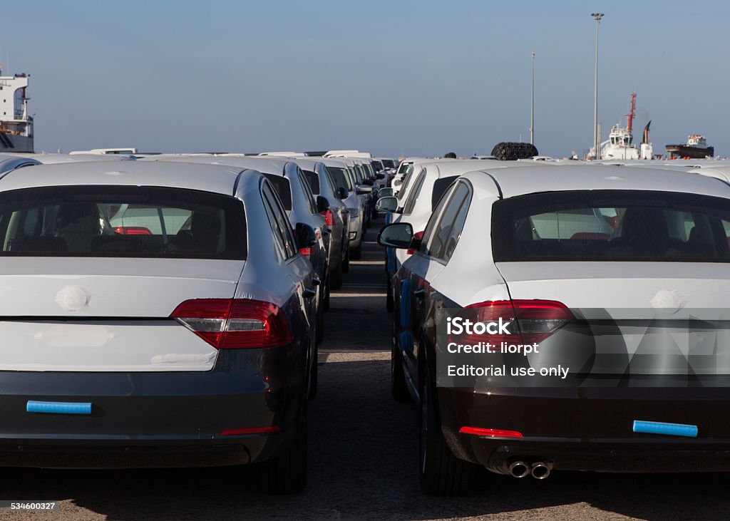 Rows of new cars covered in protective white sheet Haifa, Israel - January 23, 2015: Rows of new cars covered in protective white sheet parked in Haifa's port platform. 2015 Stock Photo