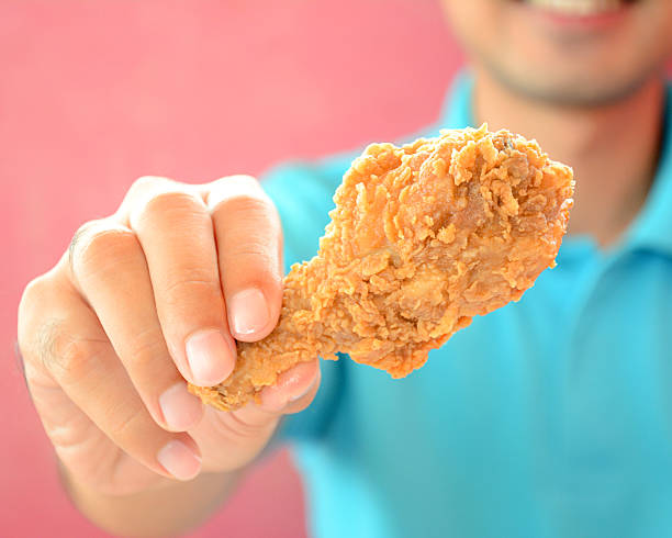 istock Hand giving fried chicken leg or drumstick 534601269