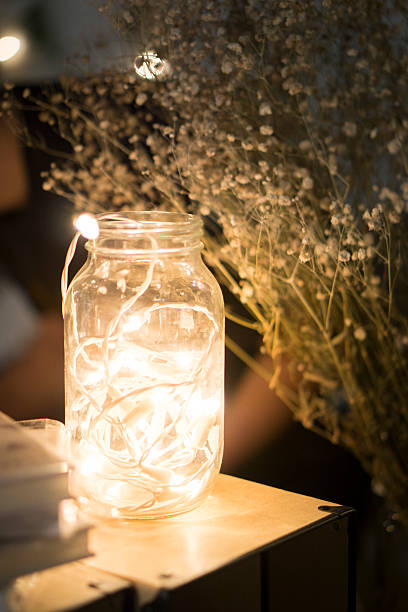 istock Light bulb wooden lamp illuminating flowers 534601613