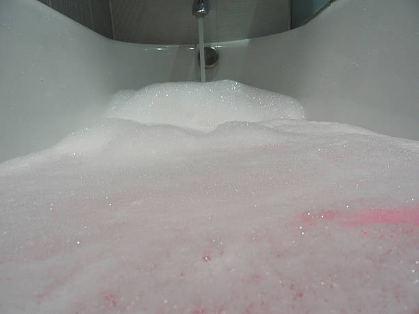 istock Modern white bathroom suite / bath, black-white tiles, pink bubbles bubblebath 534602367