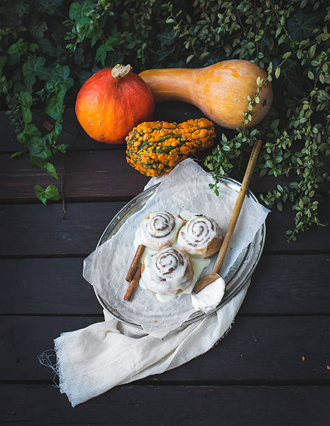 istock Cinnamon pumpkin buns with creamy cheese icing and ripe pumpkins 534602665