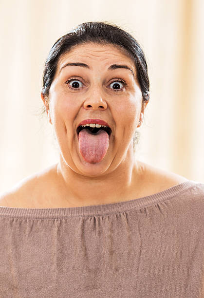 istock Fat woman sticking tongue out. 534603115