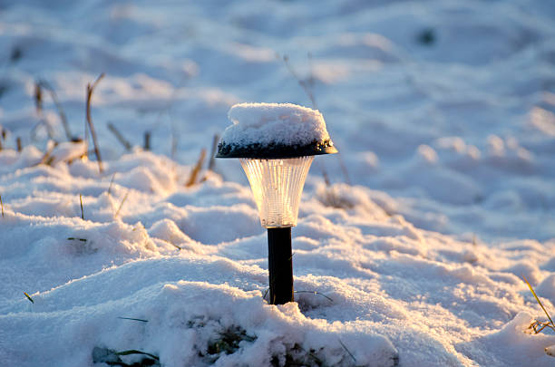 istock snowy solar garden lamp in winter 534603503