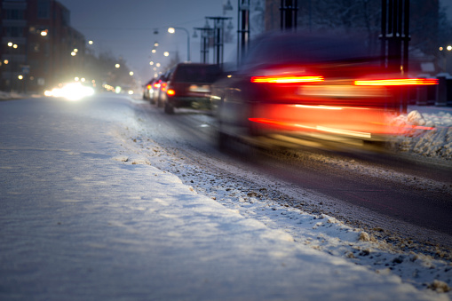 Busy traffic in snowy winter evening