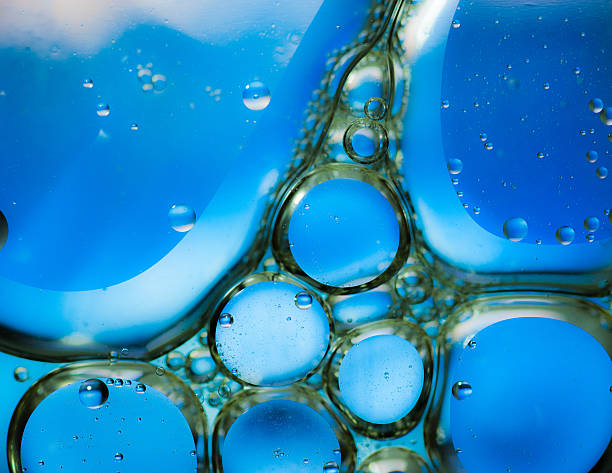 istock Oil drops on a water surface,blue background 534605035