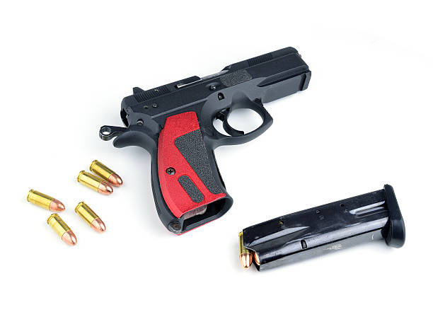 istock Black gun and 9mm bullets isolated a white background. 534605455