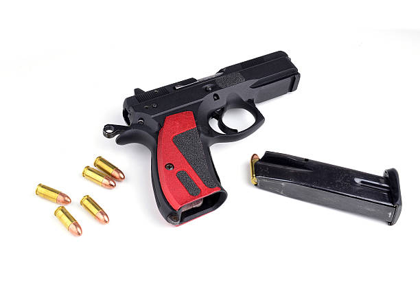 istock Black gun and 9mm bullets isolated a white background. 534605823