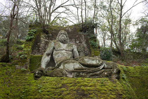 Bomarzo, Italy - January 10, 2015: Neptune statue in the gardens of Bomarzo, Viterbo province, Italy.