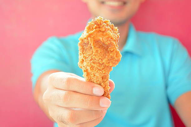 istock Hand giving fried chicken leg or drumstick 534606959