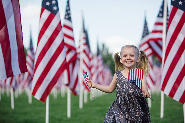 istock American preschooler running with American flag 534609688