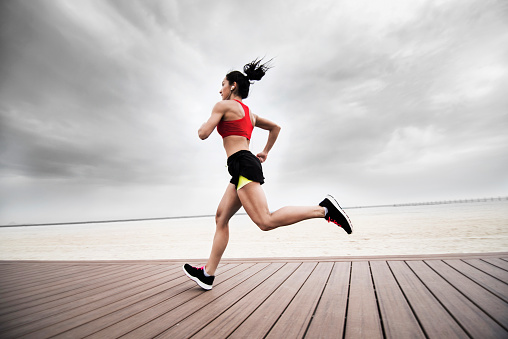 Young woman running on the beach, Dubai