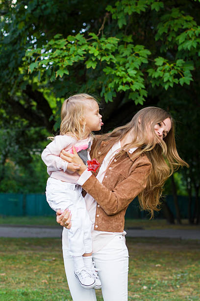 istock woman with child having fun in park 534609840