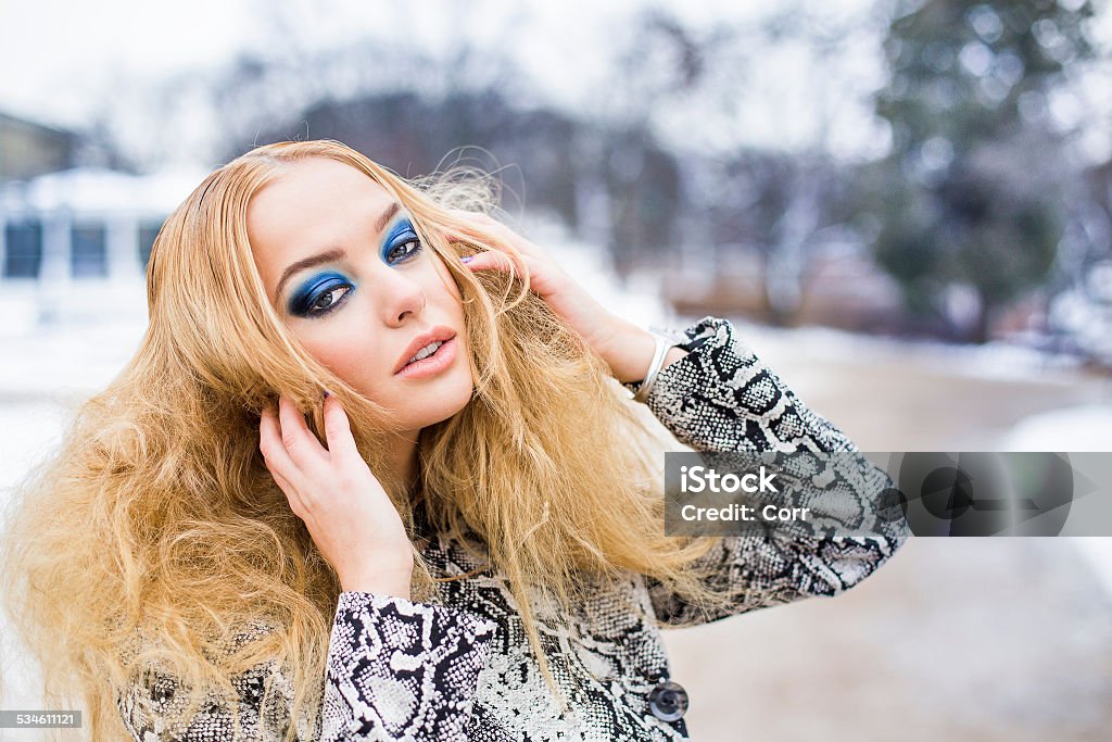 Golden haired woman posing outside Girl with a blue makeup is walking in the park 2015 Stock Photo