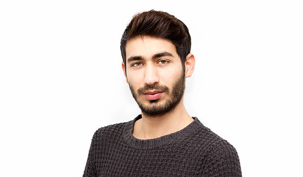 istock Portrait of young man looking at camera over white background 534626612