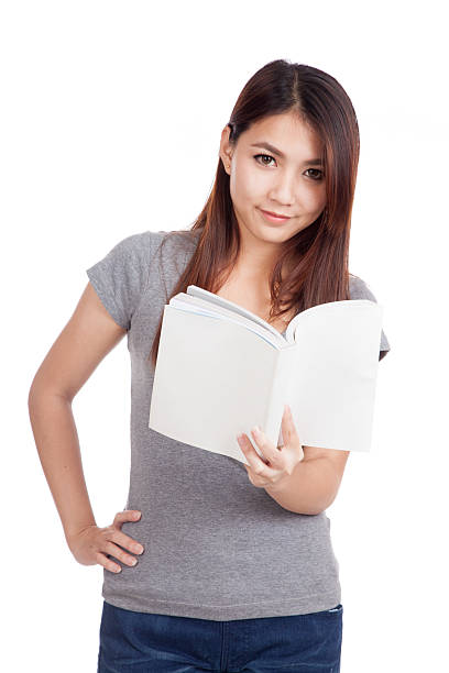 istock Young Asian woman with a book 534633729