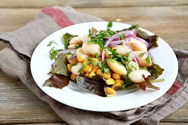 istock Tasty salad with beans, lettuce, onions and corn on plate 534633955