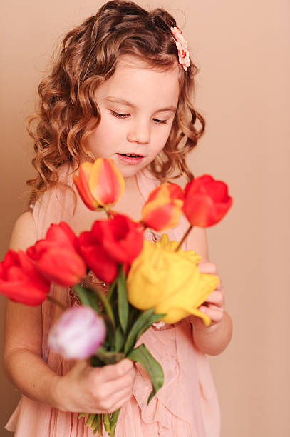 istock Cute kid girl holding flowers 534634769