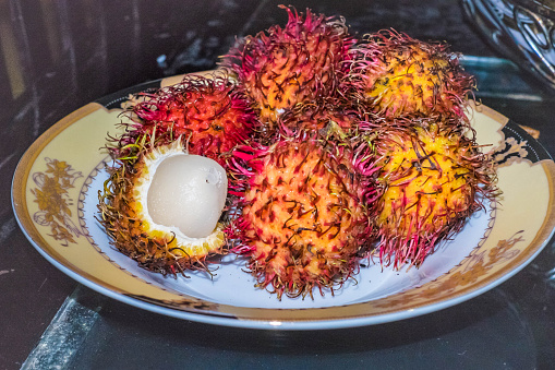 The red and yellow tropical fruit sits on display ready to be purchased.