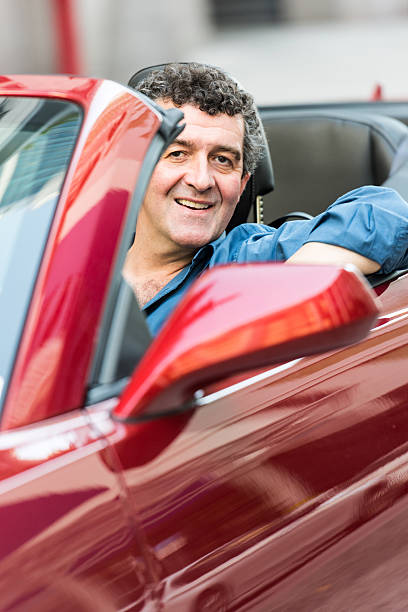 istock Mature man driving his convertible car 534638413