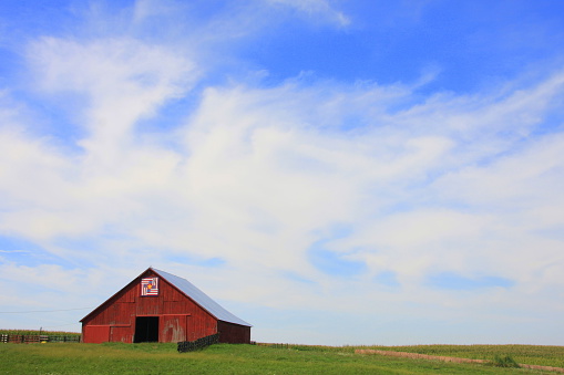 Though it looks small compared to the endless Iowa sky, this classic red barn adds a big pop of color to the landscape. 