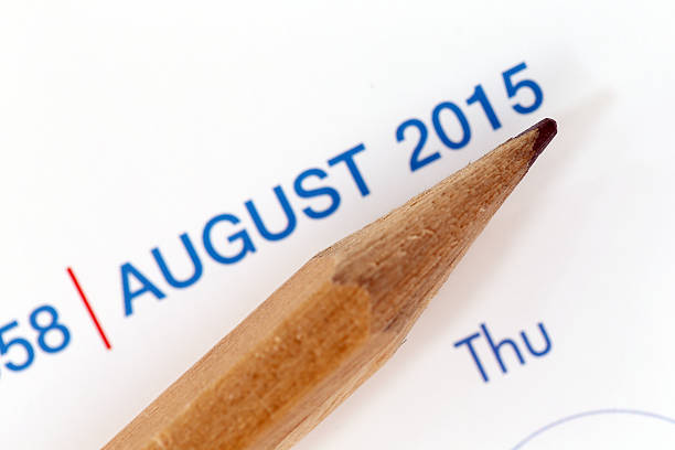The tip of a pencil point to year blur Text.