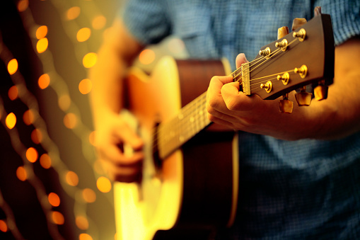 istock Man playing an acoustic guitar during a concert 534640077