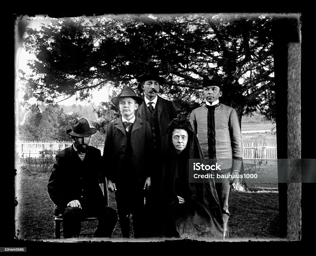 Victorian Family Portrait Beautiful Black and White portrait of a family wearing Victorian-era clothing. One person in the photo is a Cadet in a Military Academy. Photo shows the Mother who is a widow with her male children and grandchildren. The image was digitally restored from a glass plate taken circa 1890. Antique Stock Photo