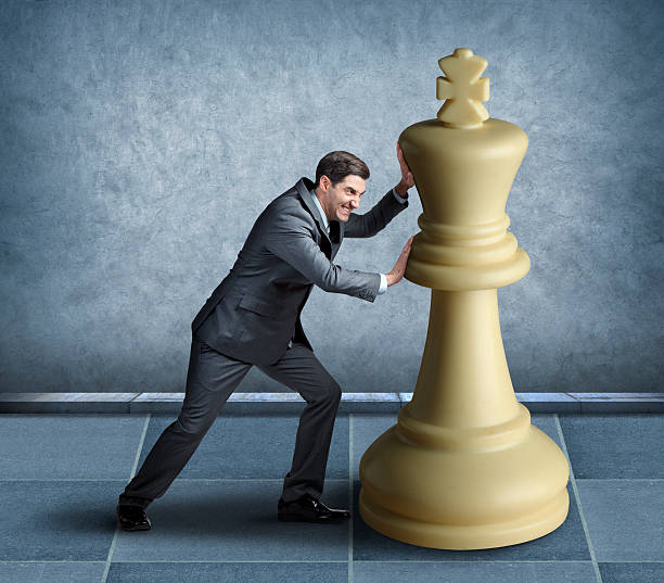 istock Businessman playing chess with oversized chess piece 534640847
