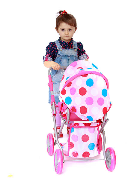 istock Little girl rolls the stroller 534640983