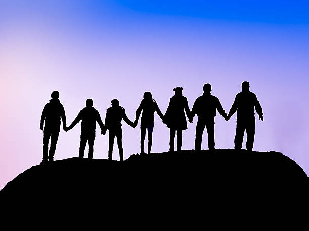 istock friends silhouette holding hand in hand 534641235
