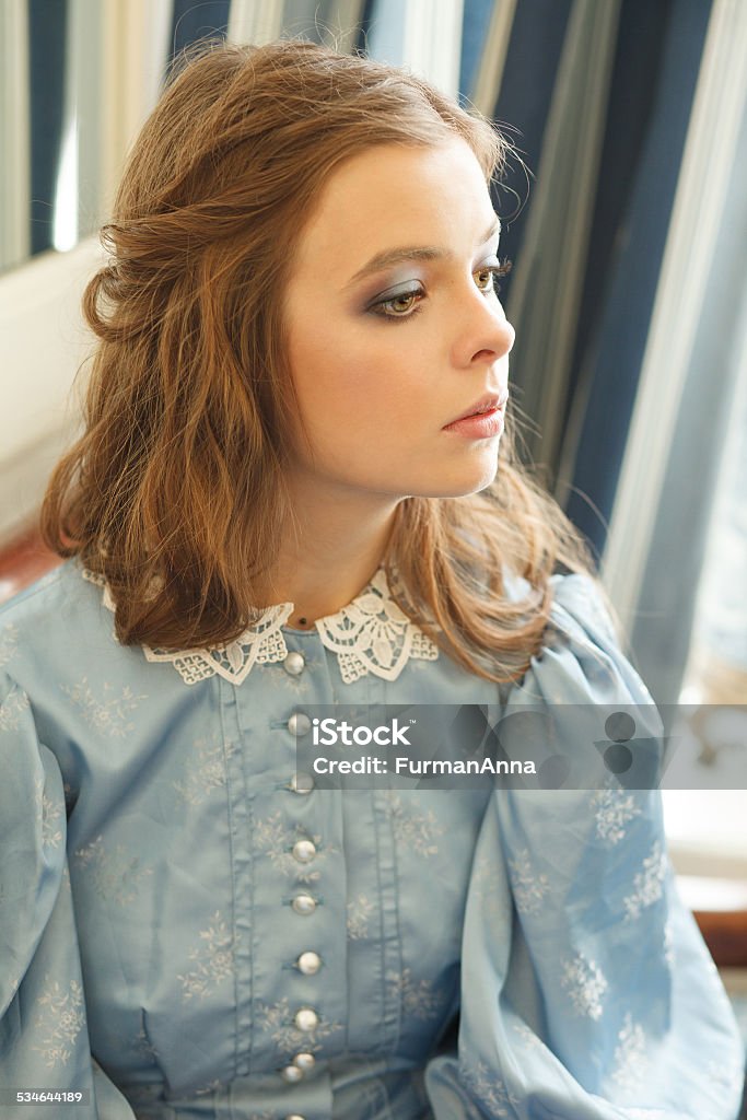 Young woman portrait Portrait of sensual young woman in vintage dress indoors in a day light. Professional style and make-up 2015 Stock Photo