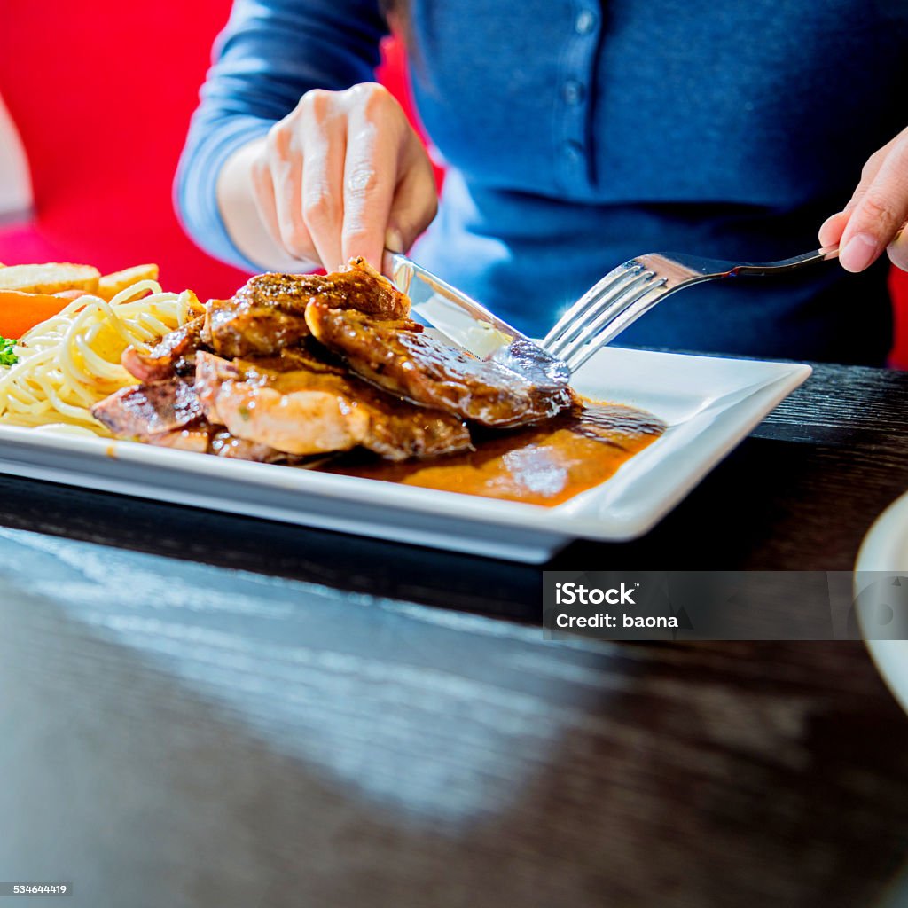 having lunch Woman having lunch at a restaurant. 2015 Stock Photo