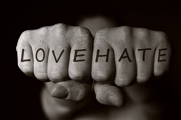 istock Two human fists as a symbol of love and hate. 534661597
