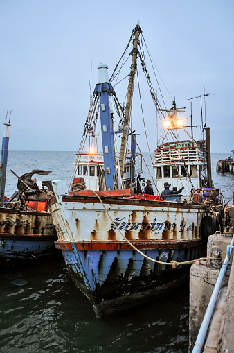 Hua Hin, Thailand - July 12, 2008: Fishermen load ice onto their boat to keep their catch fresh at the tourist resort of Hua Hin in Thailand