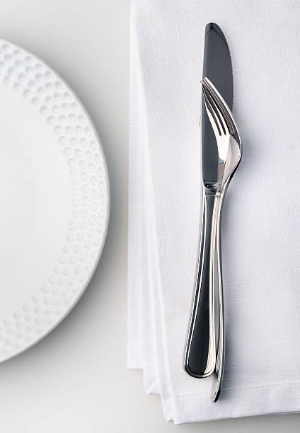 istock Knife and fork on white linnen napkin. 534662653