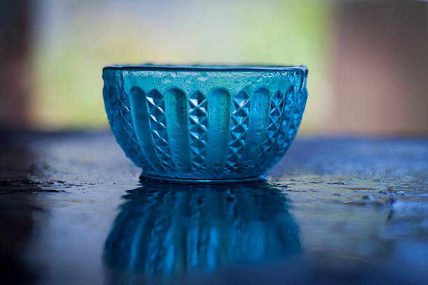 istock Antique glass bowl on the shinning surface,with blurred background. 534662696