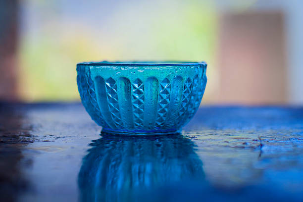 istock Antique glass bowl on the shinning surface,with blurred background. 534663388