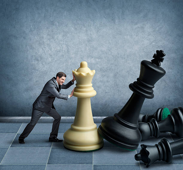 istock Businessman playing chess with oversized chess pieces 534665507