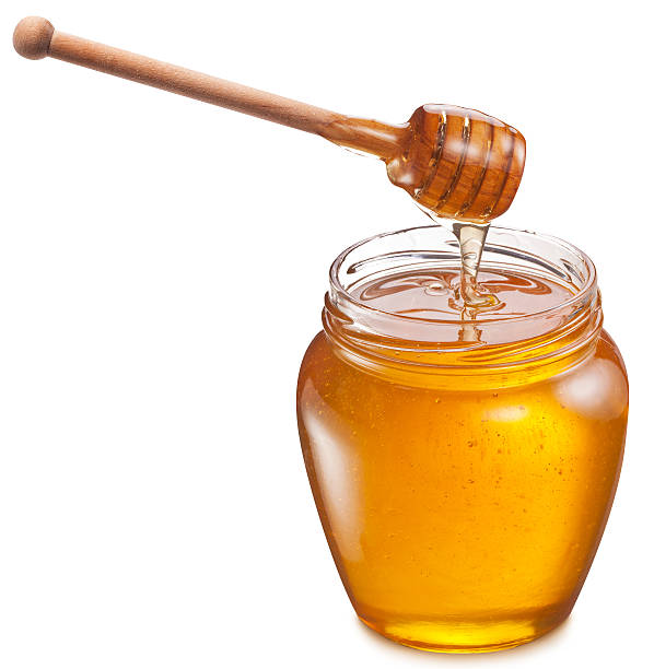 istock Honey flowing into glass jar. 534667475