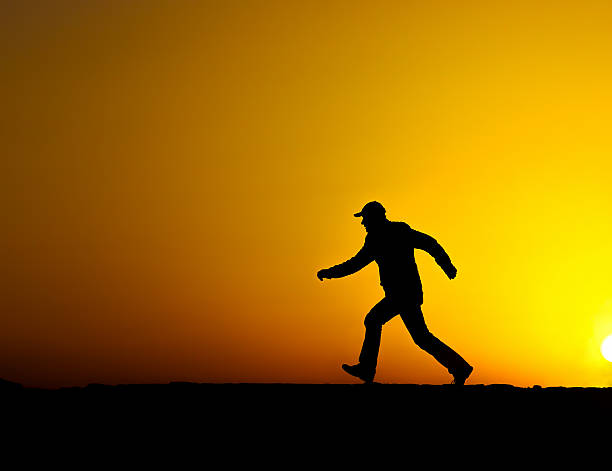 istock Silhouette of man running at sunset 534668343