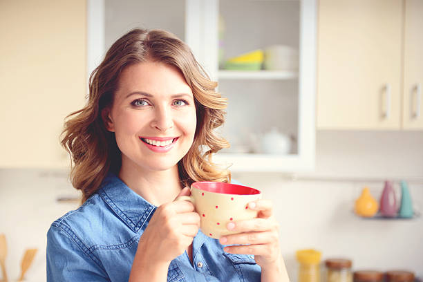 istock beautiful blonde woman in the modern kitchen 534669579
